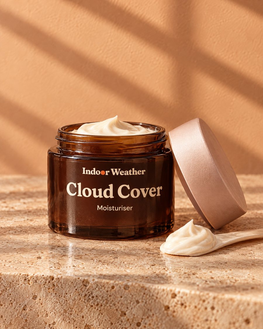 Indoor Weather Cloud Cover moisturiser jar with its lid off, in warm window light